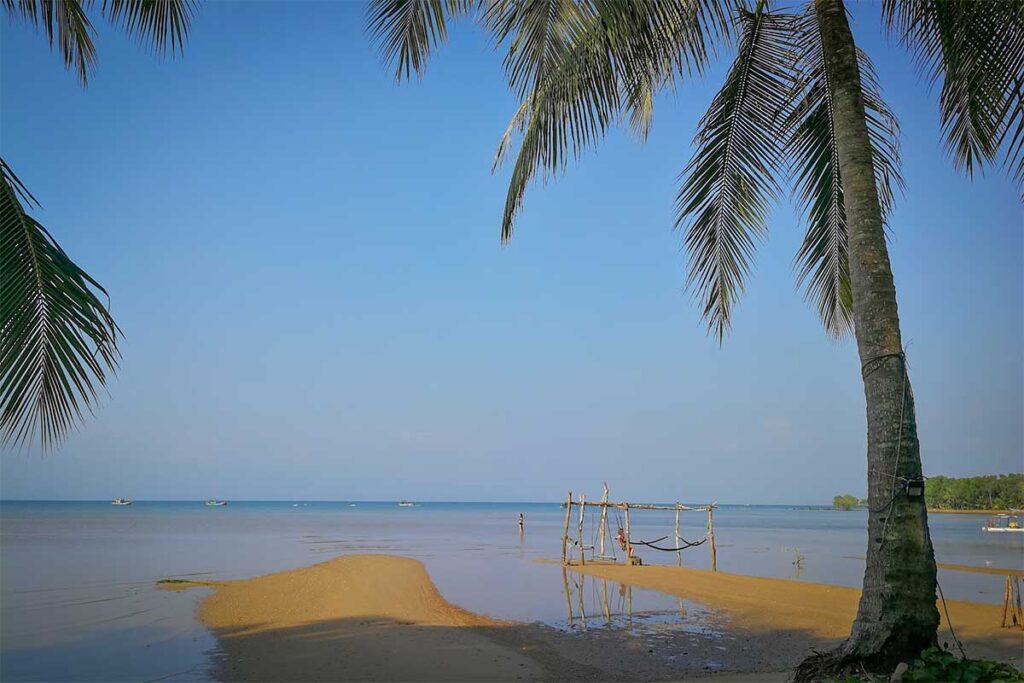 Low tide at Bai Thom Beach Phu Quoc with sandy flats hammock frame and calm sea views