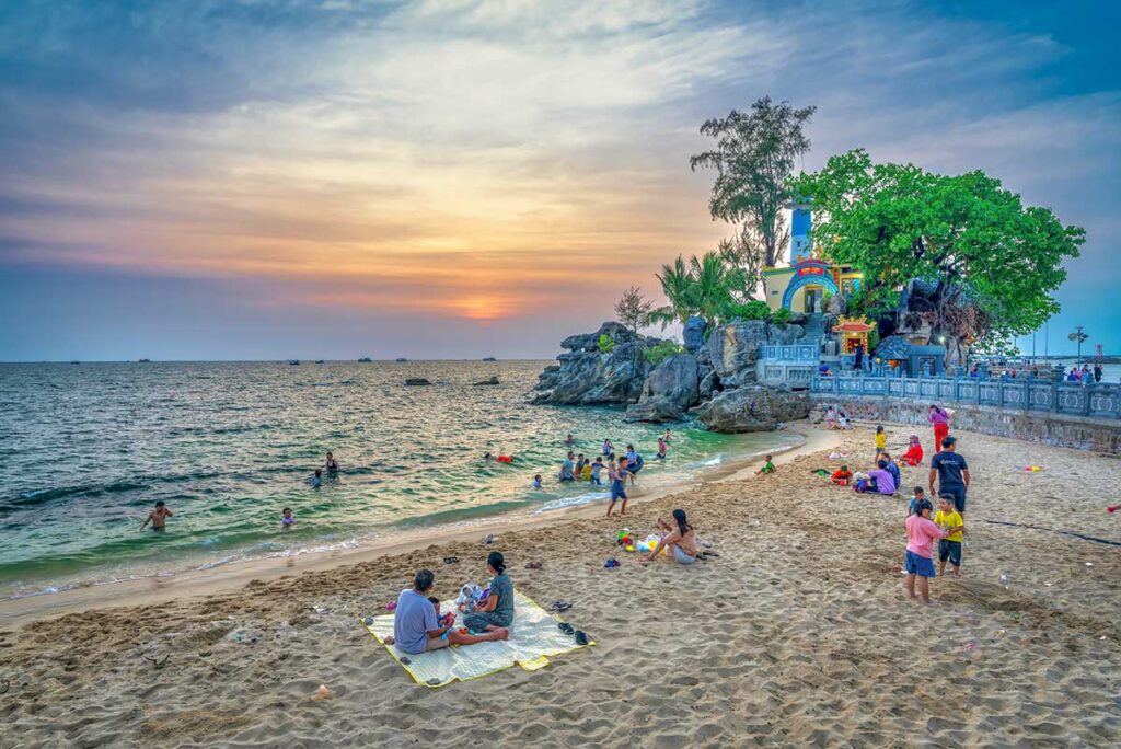 Start of Lonh Beach beside Dinh Cau Temple in Duong Dong Phu Quoc with locals at sunset