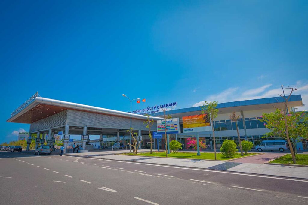 Exterior view of Cam Ranh International Airport terminal in Nha Trang with entrance road and parking area