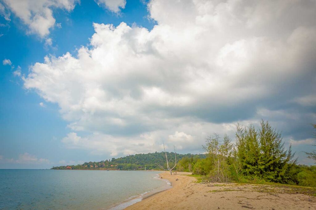 Cua Can Beach Phu Quoc quiet sandy bay with calm sea tropical shoreline and cloudy sky