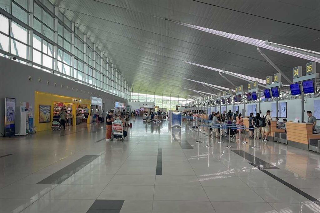 Check in counters inside Phu Quoc Airport terminal with passengers waiting for flights
