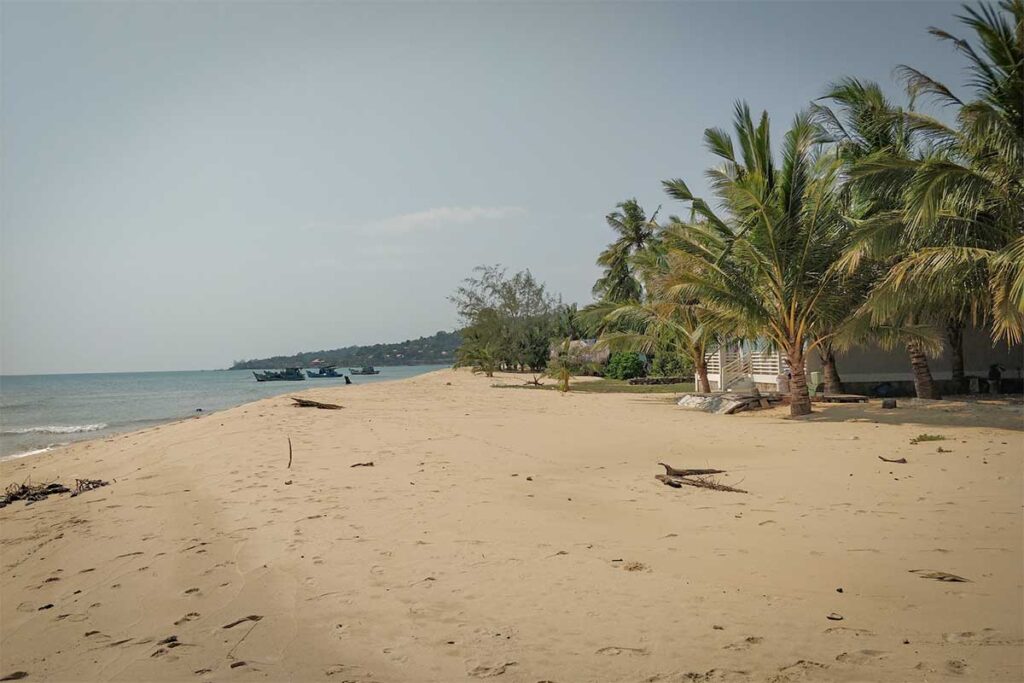 Cua Can Beach Phu Quoc quiet sandy coastline with palm trees boats and peaceful beach atmosphere