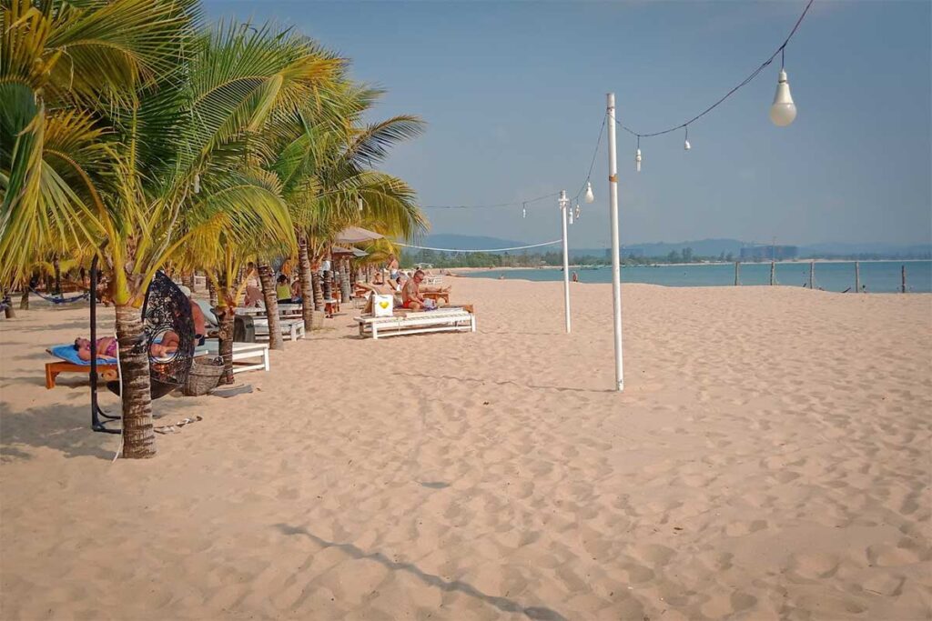 Cua Can Beach Phu Quoc beach resort area with sunbeds palm trees white sand and sea view