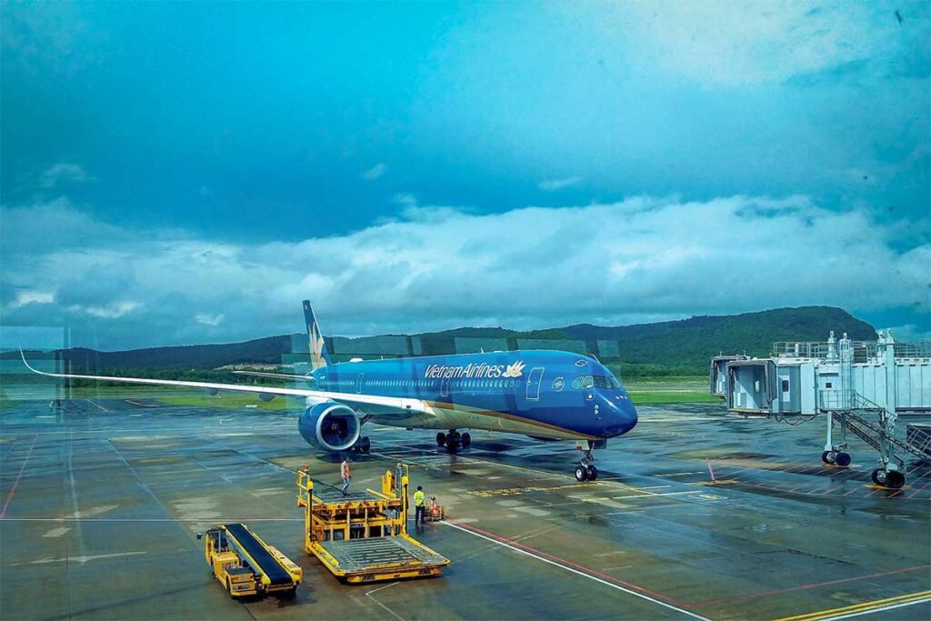 Vietnam Airlines aircraft parked at Phu Quoc Airport runway during boarding and ground handling