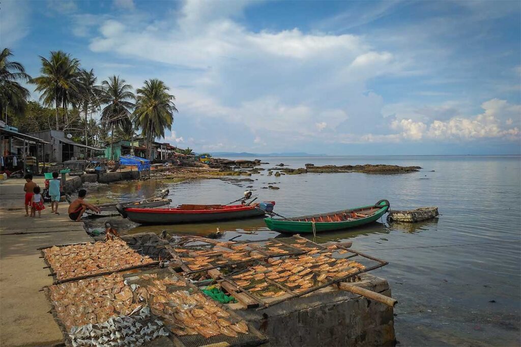 Drying fish in Ganh Dau fishing village Phu Quoc with boats and local coastal life