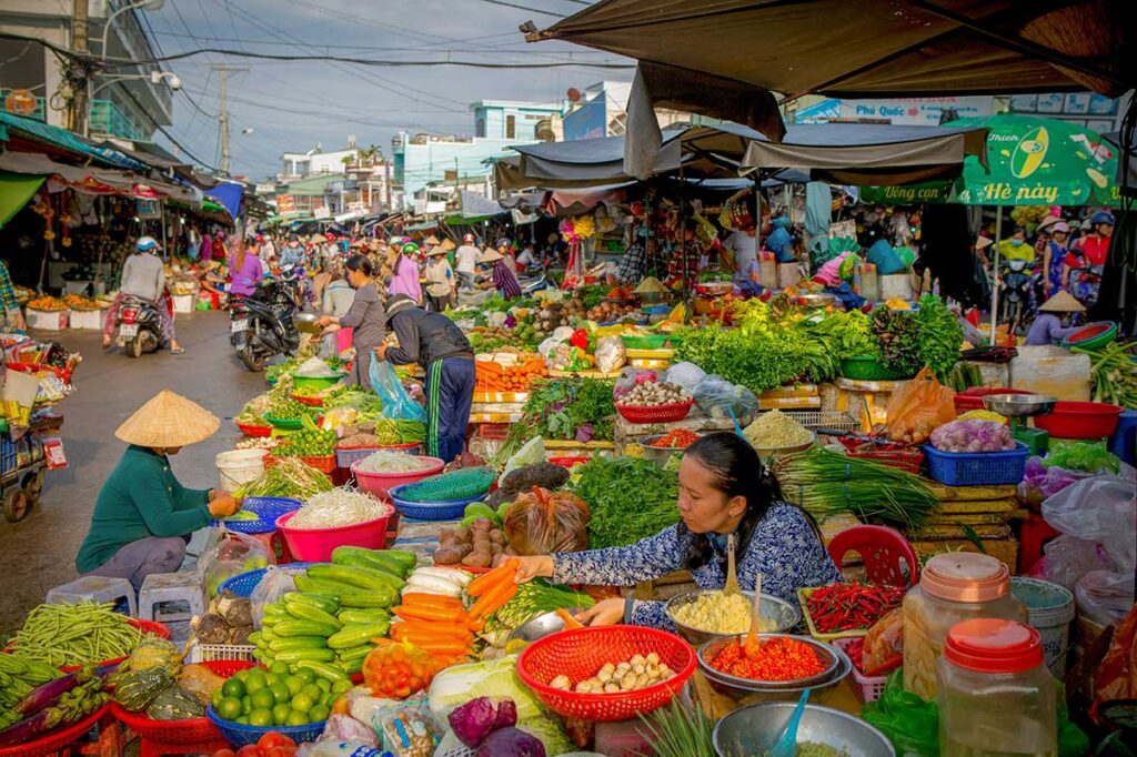Colorful vegetable stalls and local shoppers at Duong Dong Market in Phu Quoc
