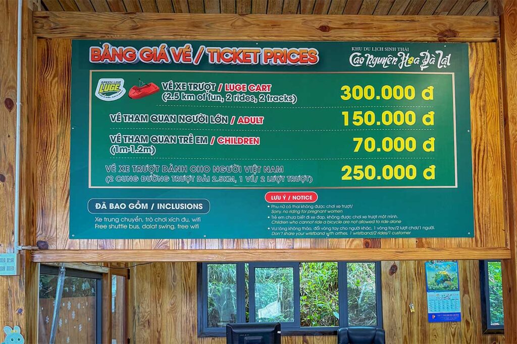 Ticket price board for Mario Kart Dalat at Cao Nguyen Hoa showing luge ride prices, entrance fees, and included services