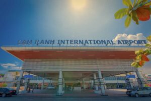 Entrance of Cam Ranh International Airport in Nha Trang with large terminal sign and drop-off area in front of the building