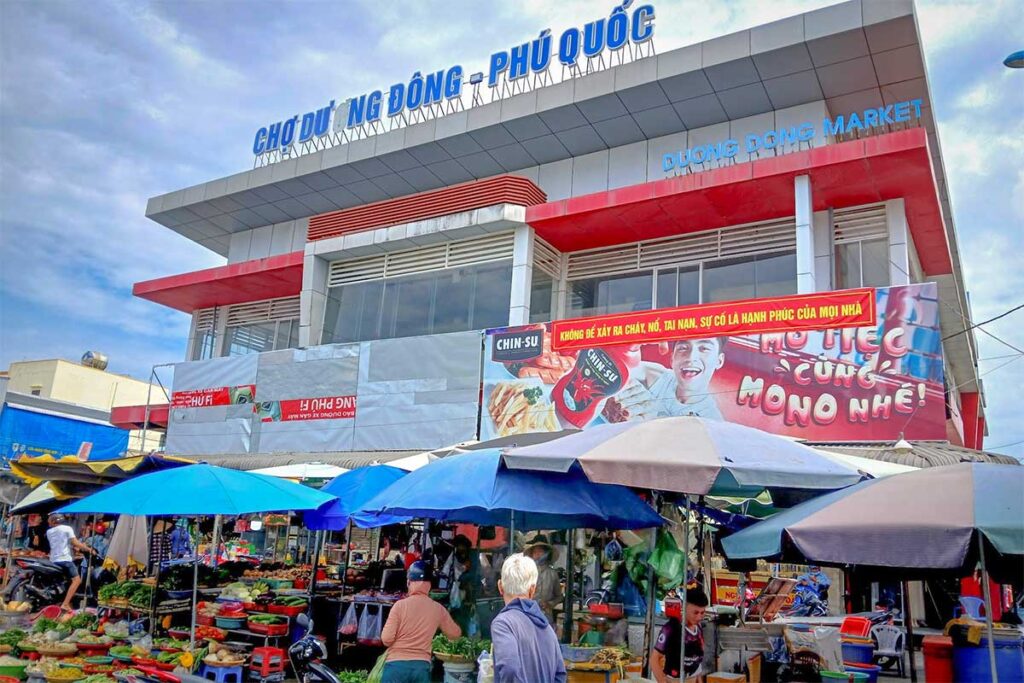 Front entrance of Duong Dong Market in Phu Quoc with outdoor produce stalls and shoppers