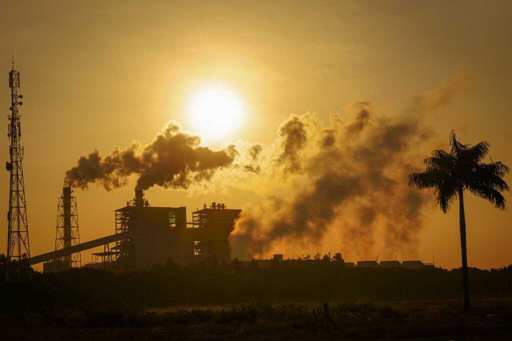 industrial factory in Vietnam releasing smoke into the air contributing to air pollution at sunset