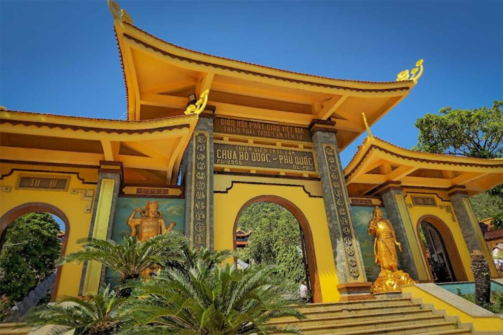 Main entrance gate of Ho Quoc Pagoda with golden guardian statues in Phu Quoc