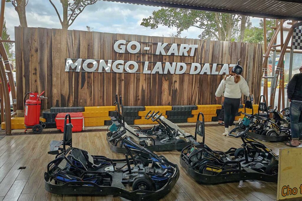 Go-kart area at Mongo Land Dalat with several parked karts and visitors preparing to ride