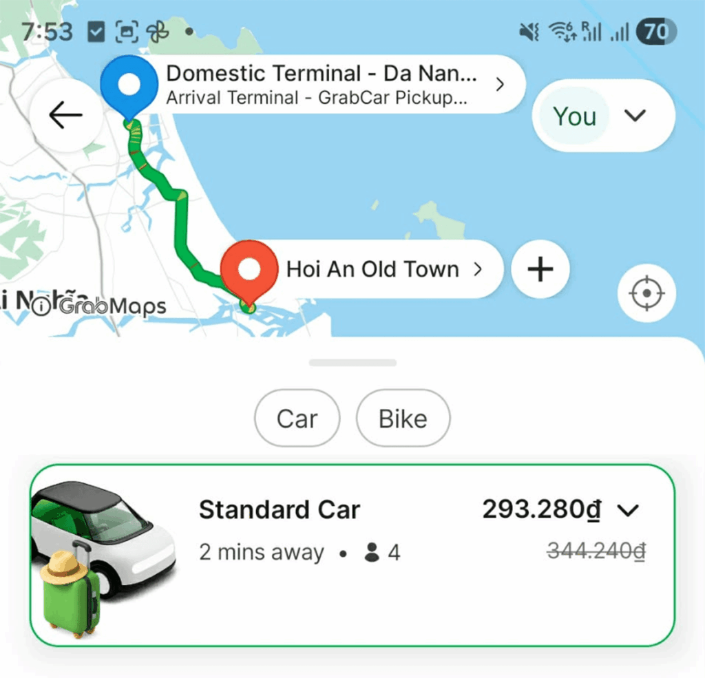 Grab ride-hailing app showing route and price from Da Nang Airport to Hoi An Old Town, a popular way to book transport between the two cities.