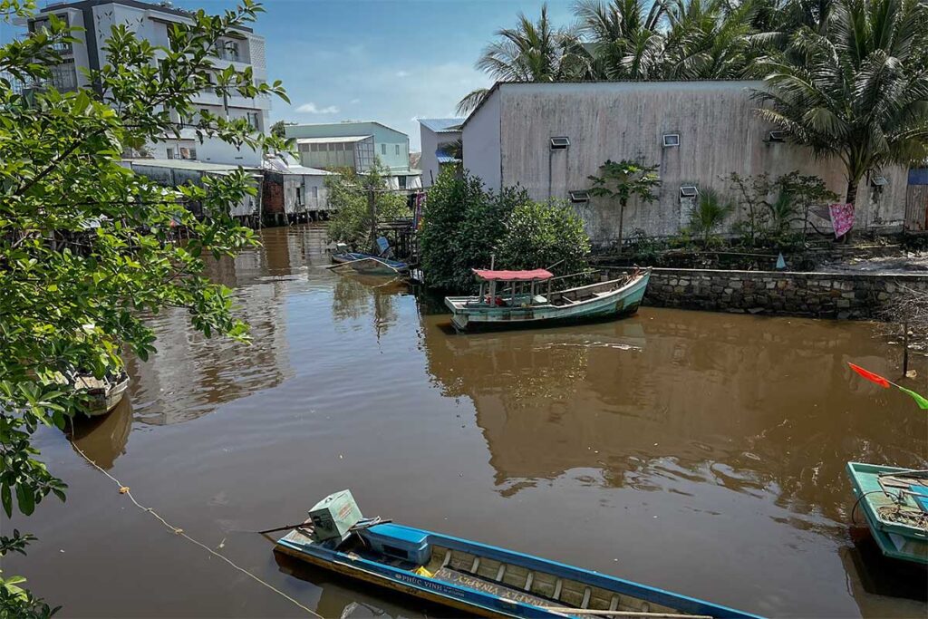 Canal with small fishing boats and waterside houses in Ham Ninh fishing village Phu Quoc