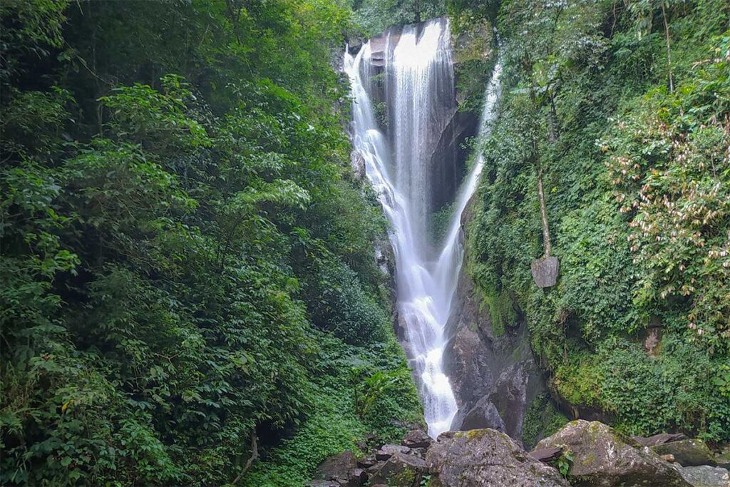 Heart Waterfall in Sin Suoi Ho surrounded by dense green forest and rocky cliffs