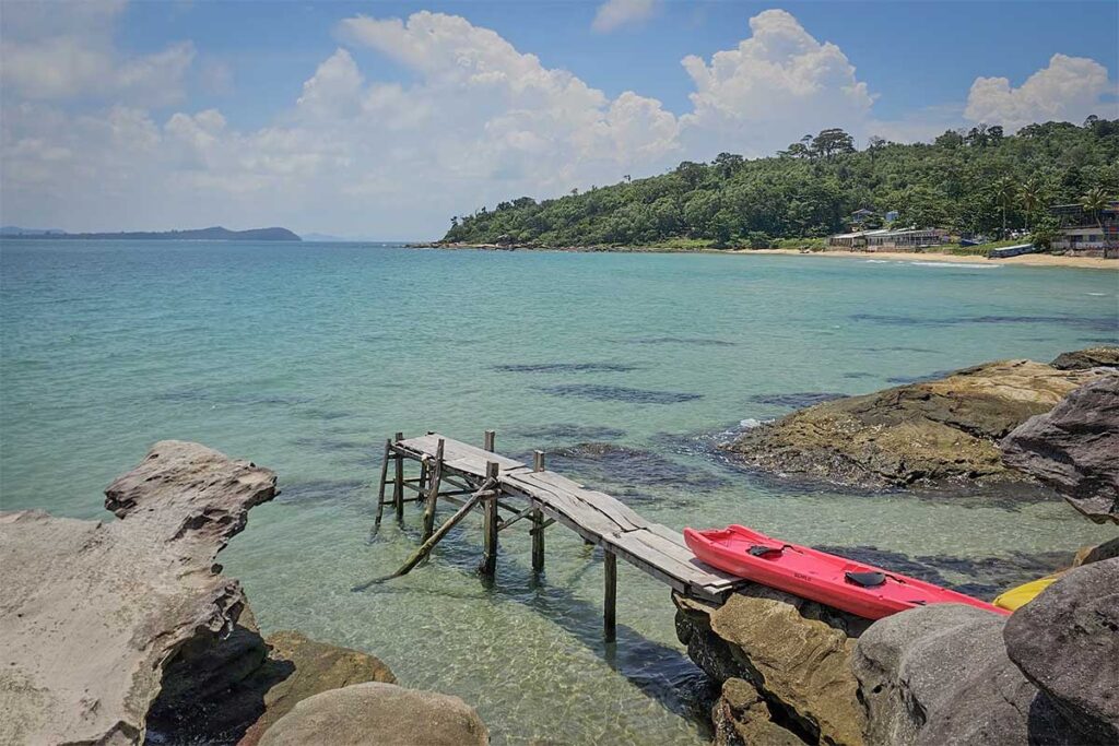 Kayak beside clear water rocky cove at Ganh Dau Cape Beach Phu Quoc
