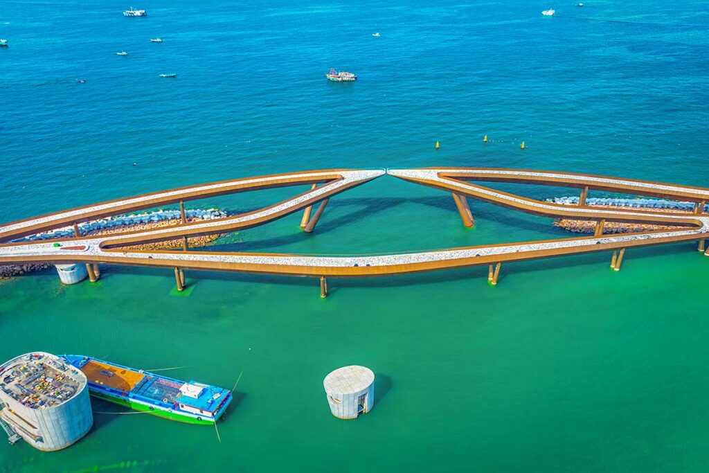 Top view of Kiss Bridge Phu Quoc showing the unique split bridge design over turquoise water and surrounding sea