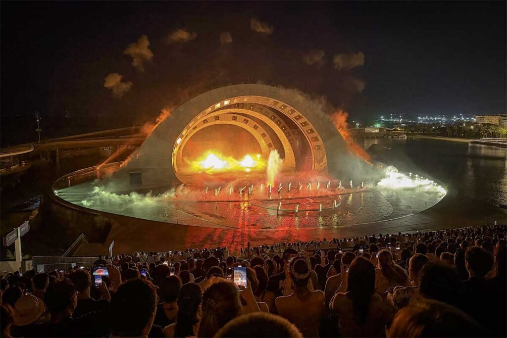 Kiss of the Sea show in Sunset Town Phu Quoc with fire effects water stage and large audience watching nighttime performance