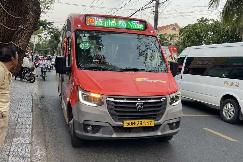 Local public bus on route between Da Nang and Hoi An, showing the budget transport option used by locals and travelers along the inland road.