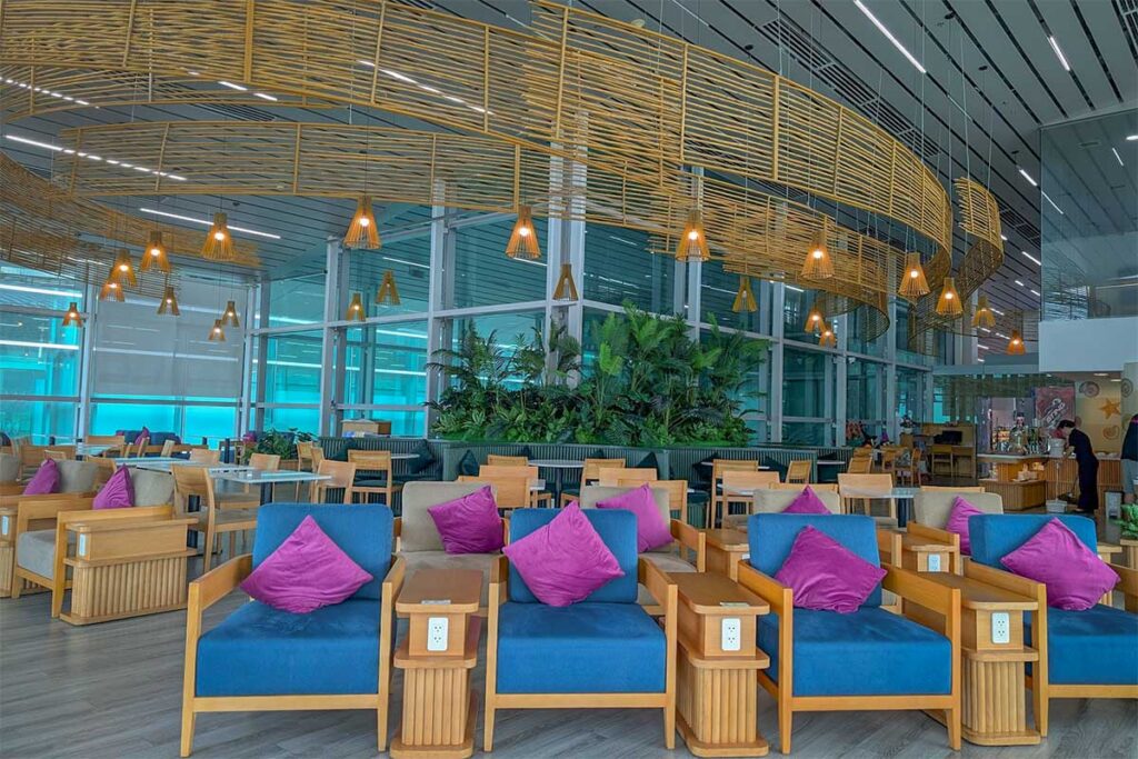 Comfortable airport lounge seating area inside Phu Quoc Airport with tables and relaxing chairs