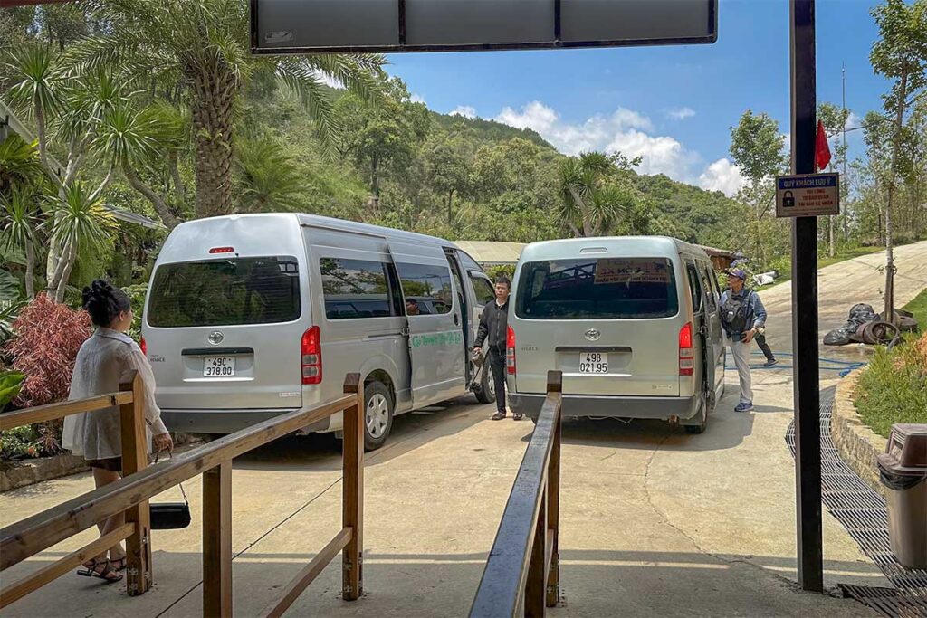 Shuttle vans transporting visitors back to the top of the Mario Kart Dalat luge track at Cao Nguyen Hoa after finishing the downhill ride