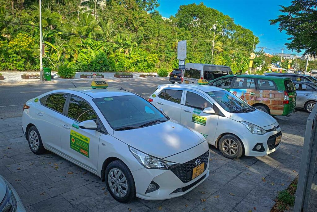 Mai Linh taxi cars in Phu Quoc waiting outside resort entrance on Tran Hung Dao road
