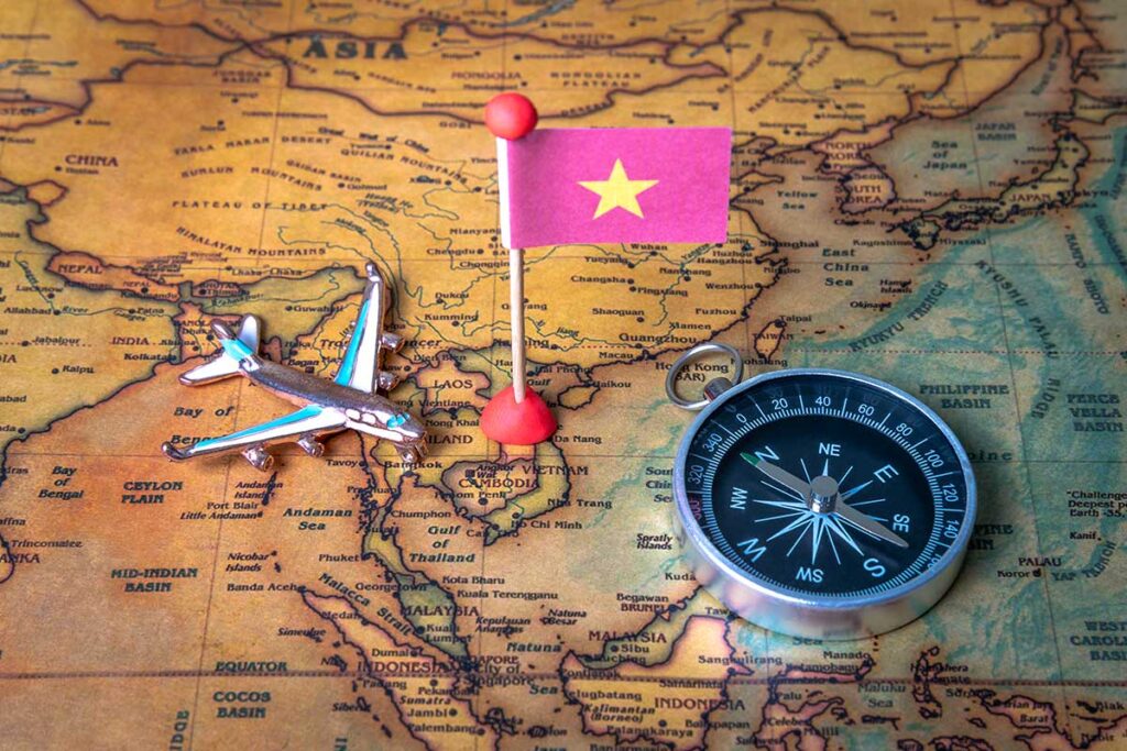 Airplane and Vietnam flag on map of Southeast Asia showing flight routes to Vietnam travel destinations