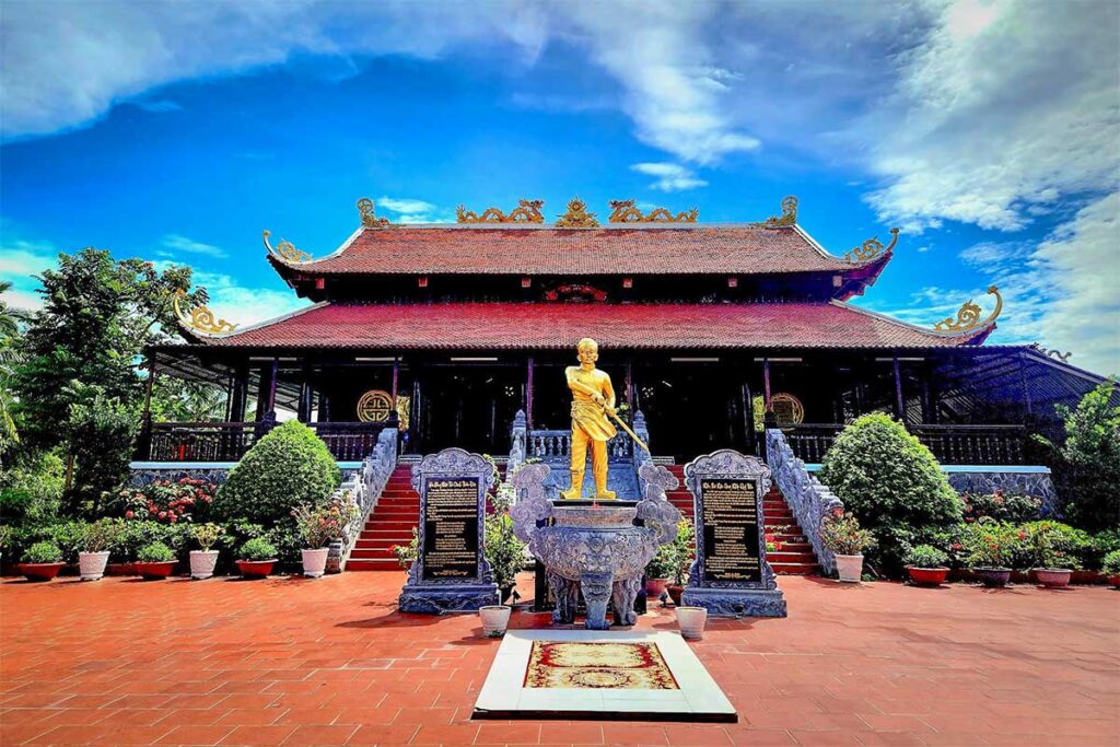 Front view of Nguyen Trung Truc Temple in Phu Quoc with golden statue courtyard and traditional architecture