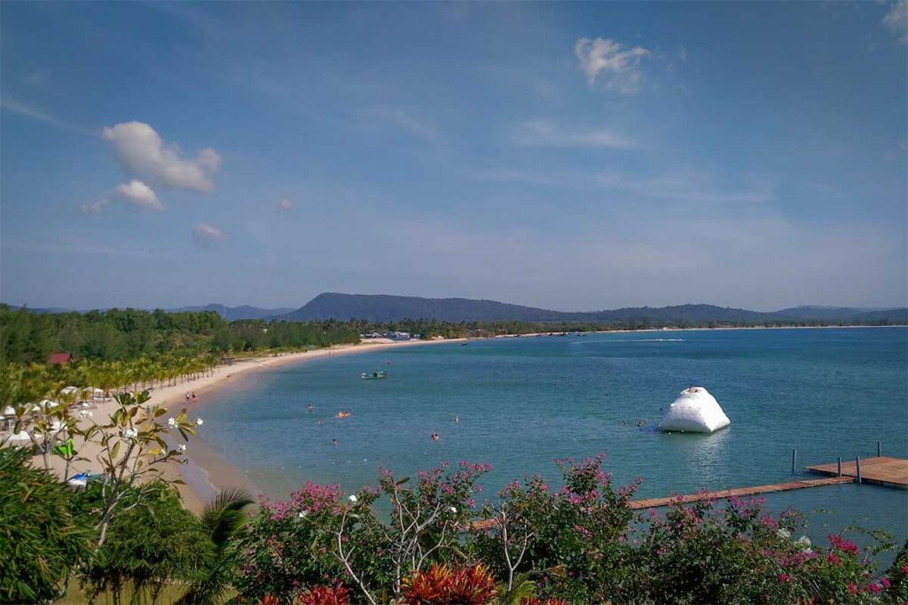 Cua Can Beach Phu Quoc panoramic view with calm blue water sandy bay and mountains in the background