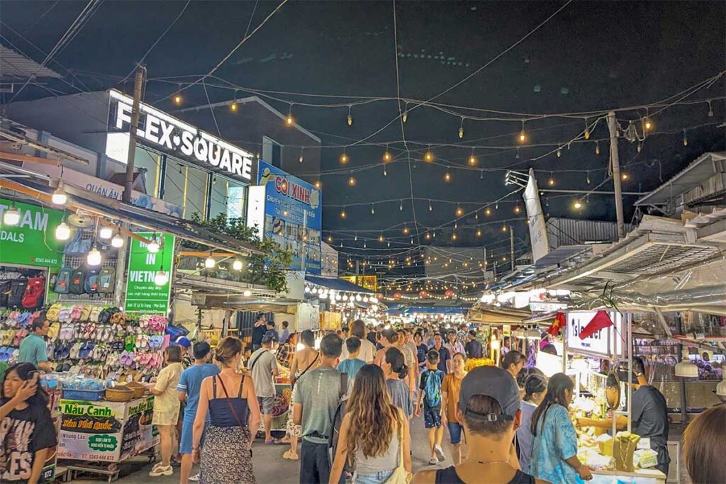 crowded walkway with tourists shopping at Phu Quoc Night Market in Duong Dong at night