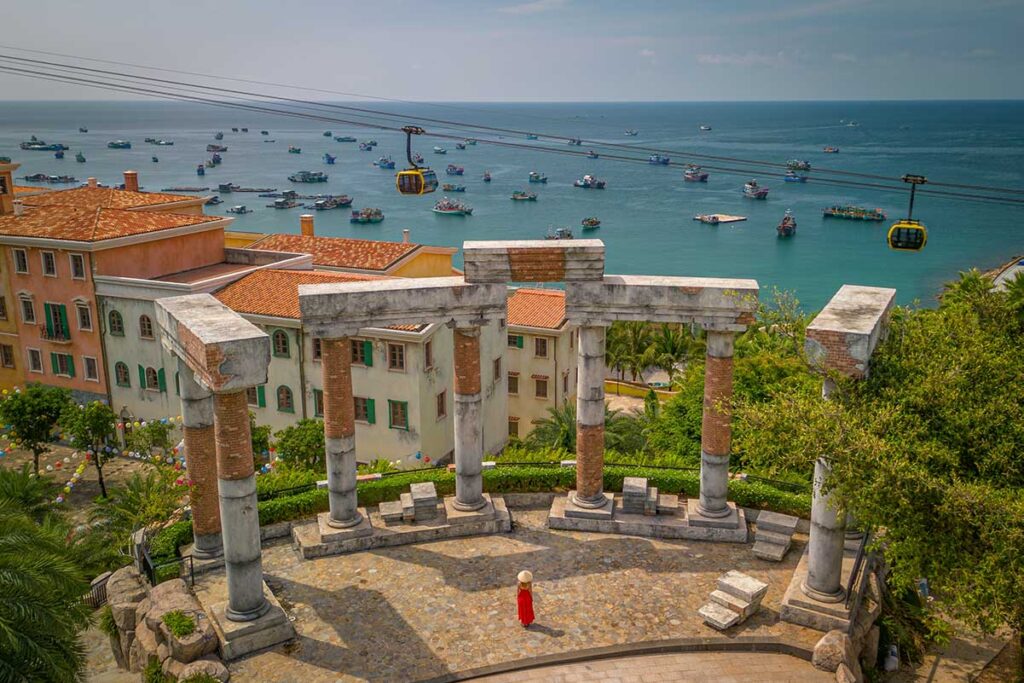 Viewpoint in Sunset Town Phu Quoc with classical columns overlooking the sea and Hon Thom cable car above fishing boats