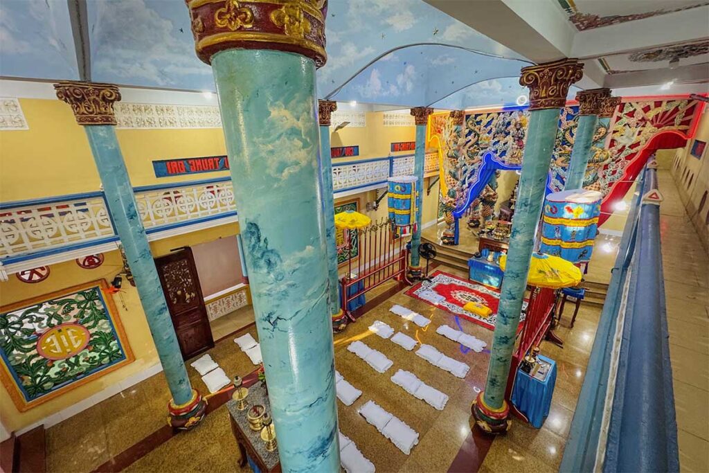 Upper floor view of the prayer hall inside Cao Dai Temple in Phu Quoc with columns and worship space