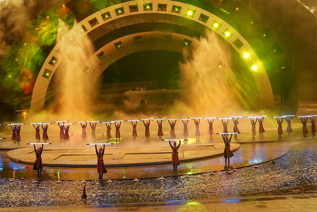Kiss of the Sea show performance with dancers on water stage surrounded by lights and mist effects in Phu Quoc
