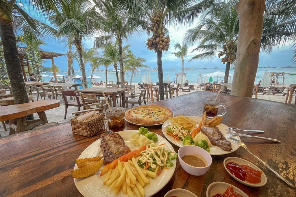 Beachfront restaurant lunch at Bai Sao Beach Phu Quoc with sea view palm trees and tropical dining