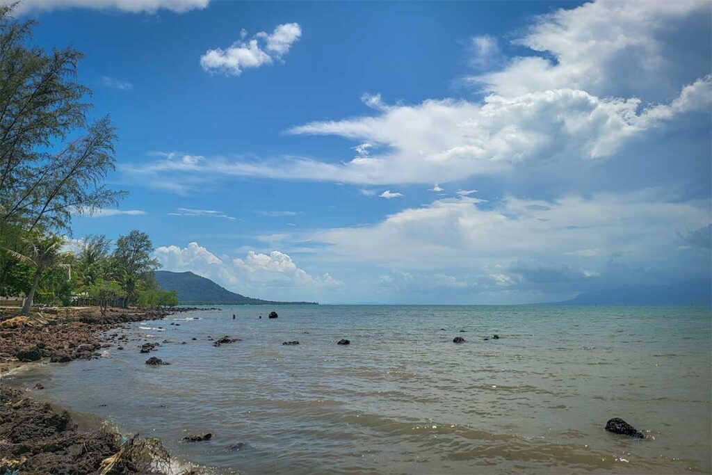 Rocky shoreline at Bai Thom Beach Phu Quoc with sea view and distant hills on the northeast coast