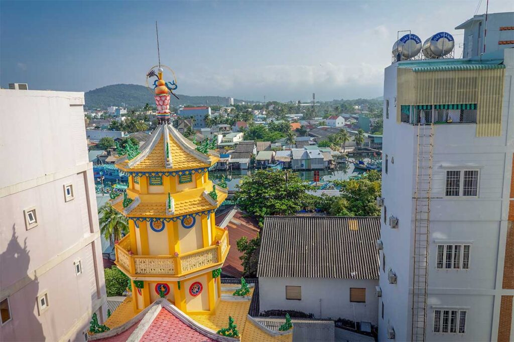 View from Cao Dai Temple tower in Phu Quoc over Duong Dong town rooftops river and temple tower