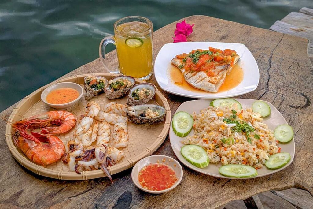 Fresh seafood lunch at floating restaurant near Starfish Beach Phu Quoc with shrimp squid and rice