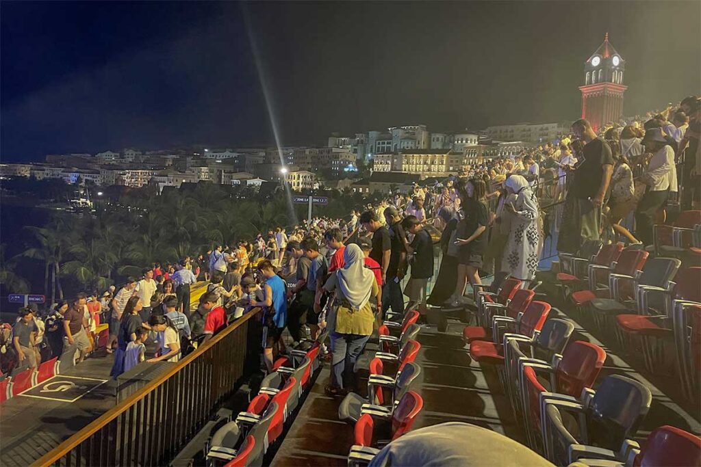 Audience seating at Kiss of the Sea show in Sunset Town Phu Quoc with large crowd and evening atmosphere
