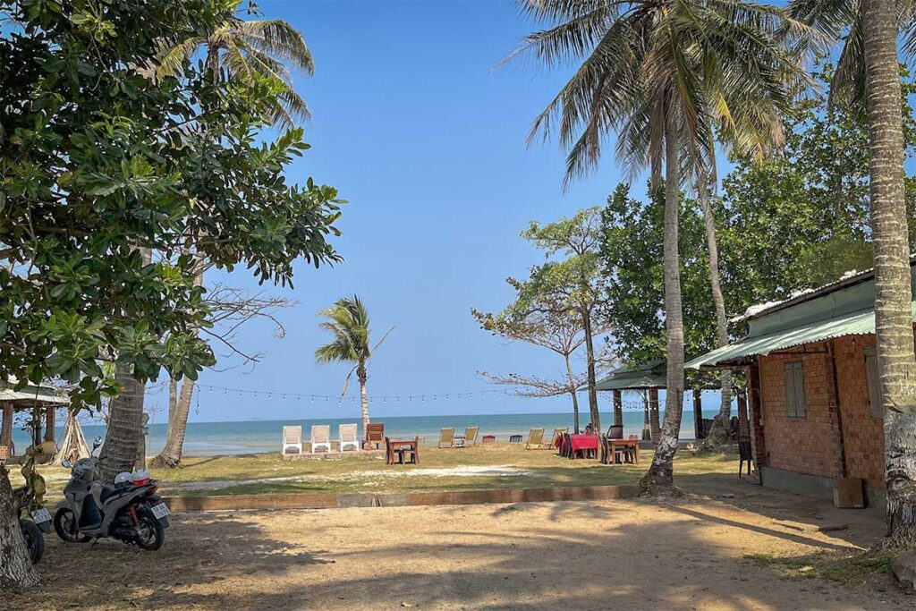 Small local resort at Bai Thom Beach Phu Quoc with simple cottages palm trees and quiet beachfront setting