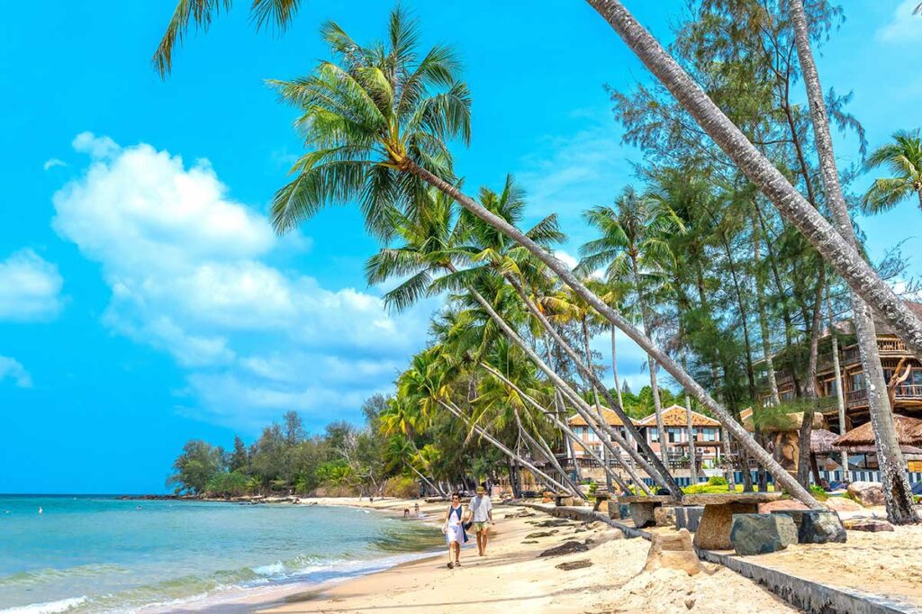 Beachfront hotels and leaning palm trees along Ong Lang Beach Phu Quoc