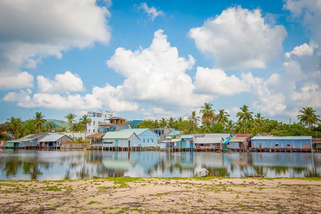 Cua Can Fishing Village Phu Quoc stilt houses by the river with reflections and tropical palms