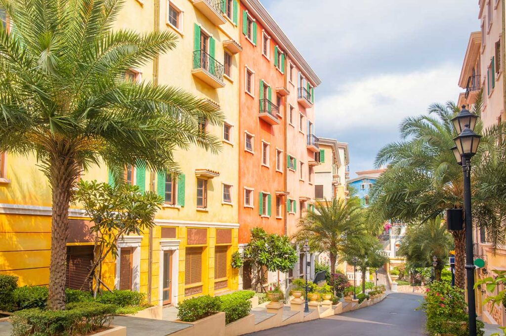 Colorful Mediterranean style street in Sunset Town Phu Quoc with palm trees bright facades and quiet walking area