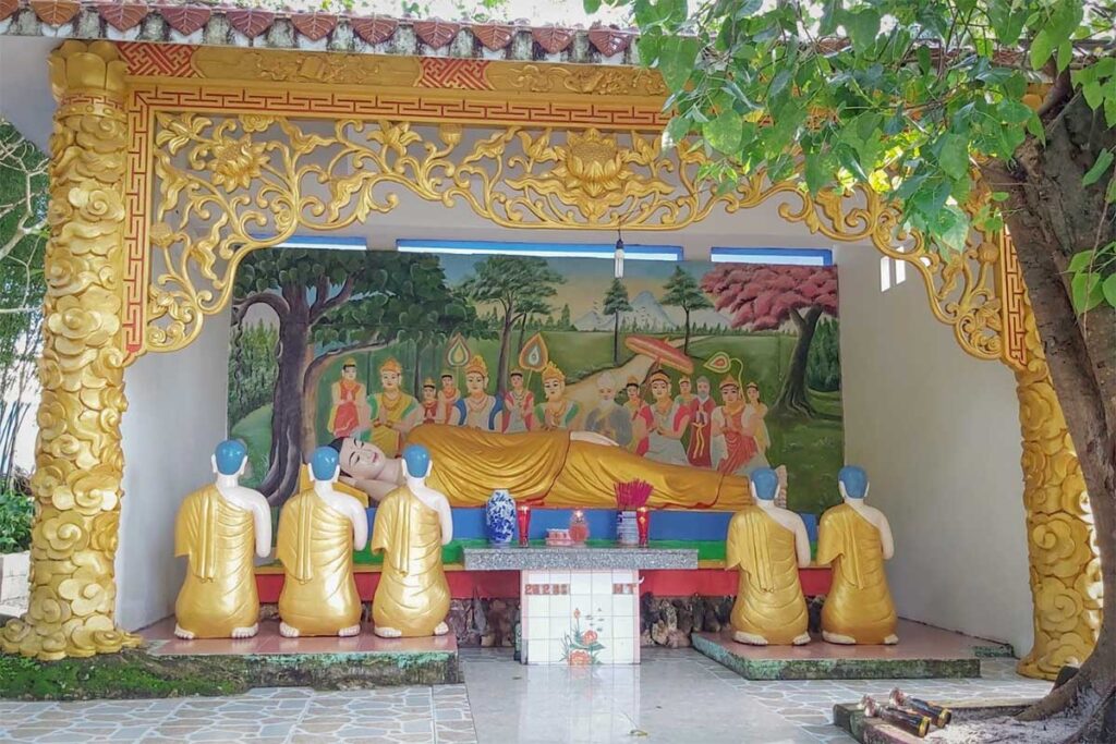 Outdoor Buddha statues at Sung Hung Pagoda in Phu Quoc showing reclining Buddha and peaceful temple shrine