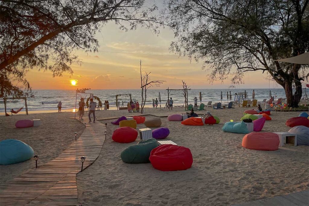 Sunset at Bai Dai Beach Phu Quoc with bean bags on the sand and sea view lounge area