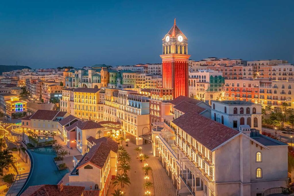 Sunset Town Phu Quoc at night with illuminated clock tower colorful buildings and lively evening atmosphere