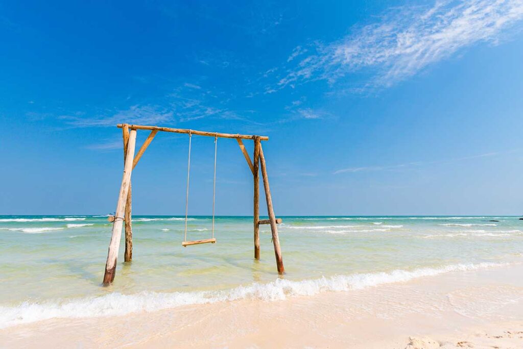 Wooden swing in the sea at Bai Sao Beach Phu Quoc with white sand and clear water