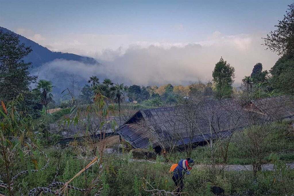 Hmong village houses in Sin Suoi Ho surrounded by greenery and morning mist in the mountains of Lai Chau