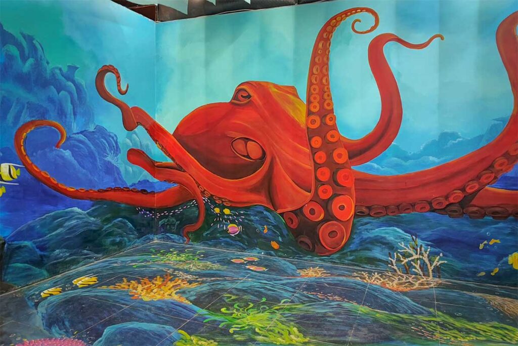Colorful 3D ocean mural inside Lang Chai Xua Fish Sauce Museum featuring a giant octopus, popular with visitors for photos