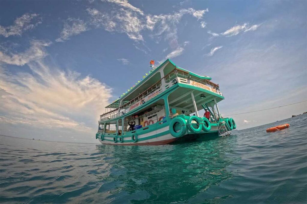 diving boat floating near reef during scuba diving trip in Phu Quoc