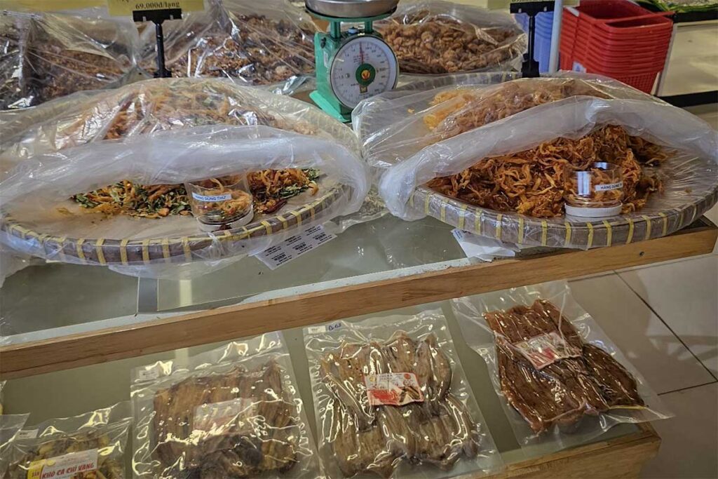 Dried seafood products and local food souvenirs for sale in a Phu Quoc market with packaged fish squid and seafood snacks